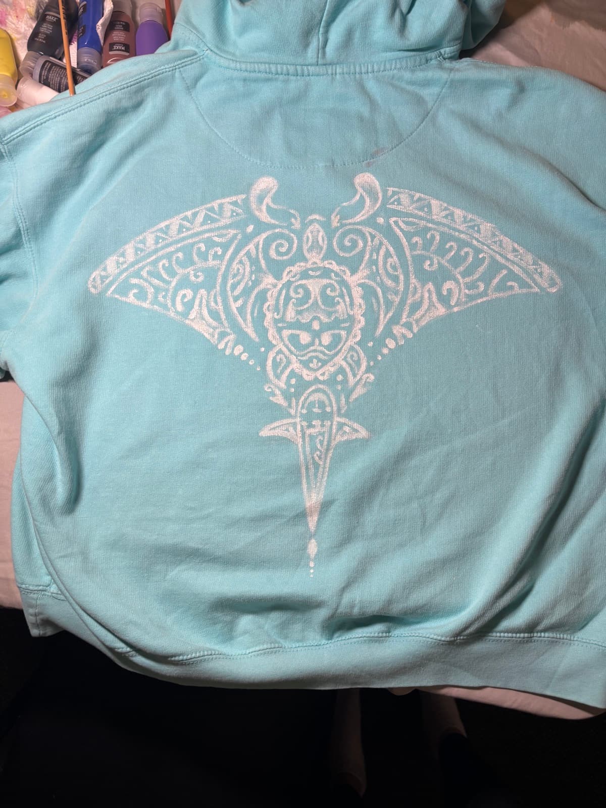 Hand-painted tribal manta design, back view, on a custom sweatshirt by Madeleine MacNutt